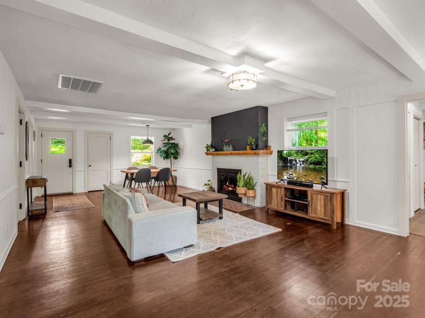 1463 Carolina Drive, Tryon, NC 28782.  MLS# CAR4275838, YatesRealty ID 24578. Living Room and Dining area.  Door on the left is the front entrance and the door on the right is a coat closet.