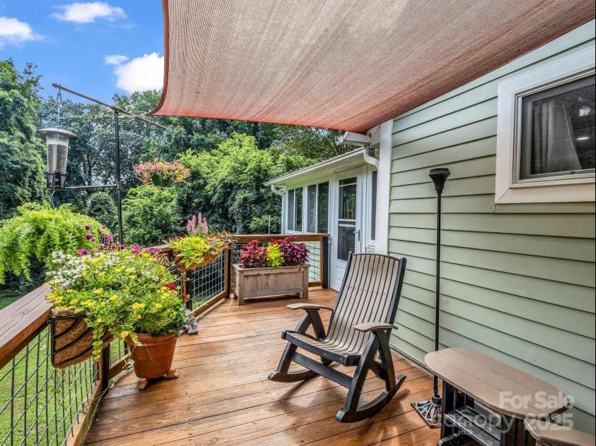 55 Lanier Street, Tryon, NC 28782.  MLS# CAR4276208, YatesRealty ID 24579. Deck off of the Dining Area and the enclosed porch