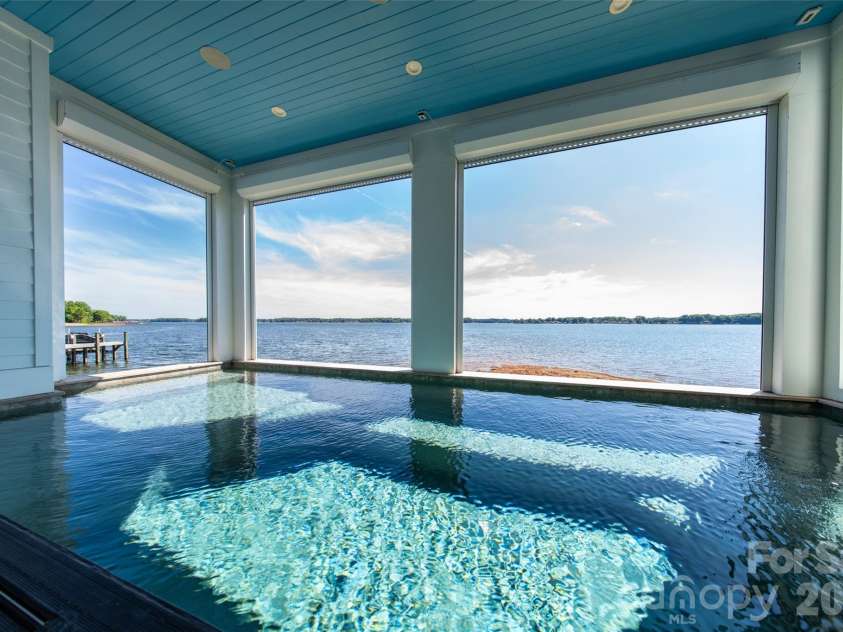 4835 Kiser Island Road, Terrell, NC 28682.  MLS# CAR4379582, YatesRealty ID 24580. RESORT STYLE LIVING AT ITS FINEST.  BEAUTIFUL PLANK CEILING, MODERN STRUCTURAL PILLARS WITH AUTOMATIC CROCI SHUTTERS FROM CEILING TO POOL TOP CREATING JUST ANOTHER REASON TO STAY AT HOME AND EMBRACE THE PICTURE PERFEC