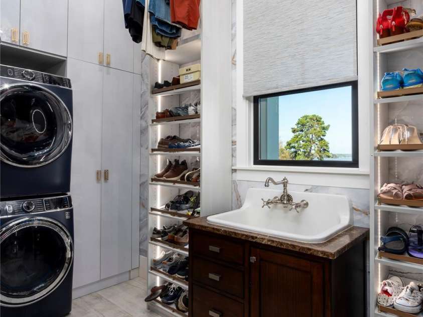 4835 Kiser Island Road, Terrell, NC 28682.  MLS# CAR4379582, YatesRealty ID 24580. ULTRA-LUXURY LAUNDRY DESIGNED FOR ULTIMATE ORGANIZATION. FEATURING PREMIUM FRONT-LOAD WASHER AND DRYER SET, AN ELEGANT DARK WOOD VANITY WITH A DEEP FARMHOUSE-STYLE UTILITY SINK, FLOATING CHANDELIER WITH MOTORIZED LIFT