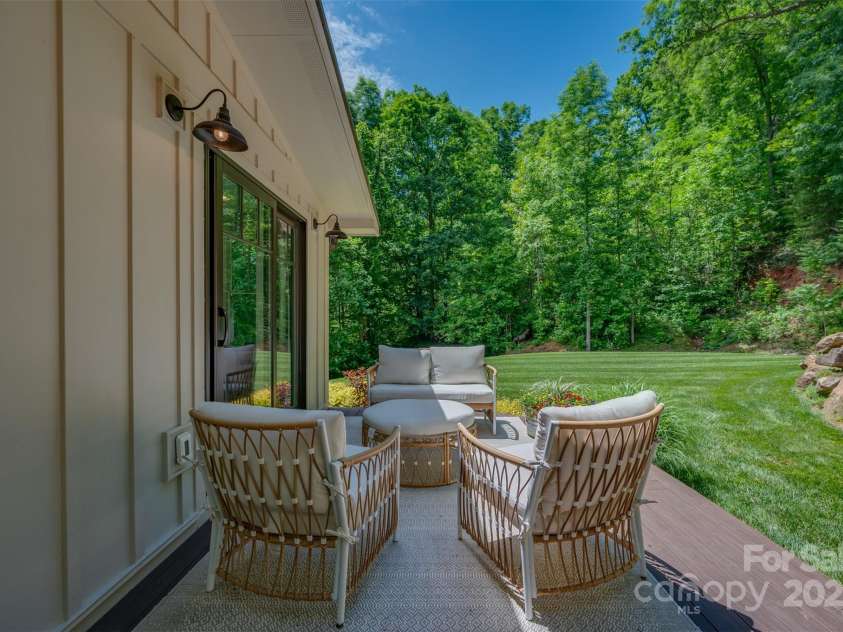 54 Holland Drive, Columbus, NC 28722.  MLS# CAR4309470, YatesRealty ID 2459. Patio door from primary bedroom