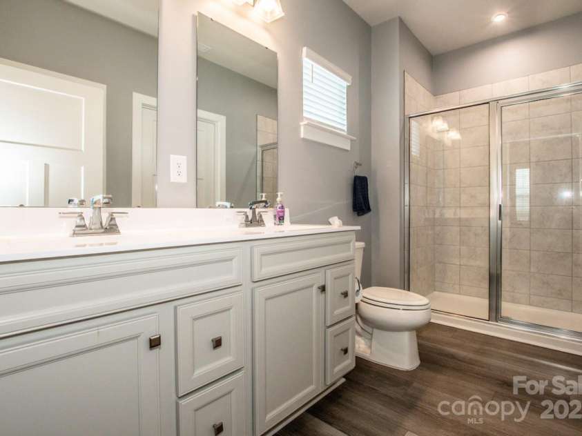 105 Chase View Lane, Troutman, NC 28166.  MLS# CAR4256483, YatesRealty ID 24599. Ensuite bath with double vanity and large walk in tiled shower