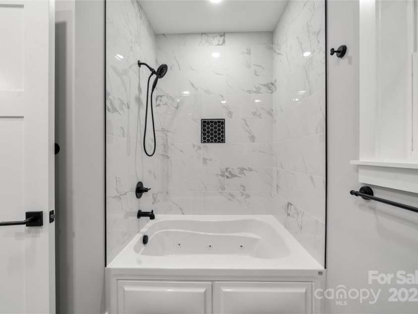 68 Bamboo Trail, Candler, NC 28715.  MLS# CAR4257307, YatesRealty ID 24635. Deep soaking tub in primary in addition to another shower