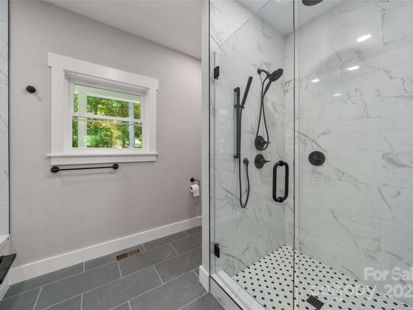 68 Bamboo Trail, Candler, NC 28715.  MLS# CAR4257307, YatesRealty ID 24635. Gleaming primary spa bath with heated floors!