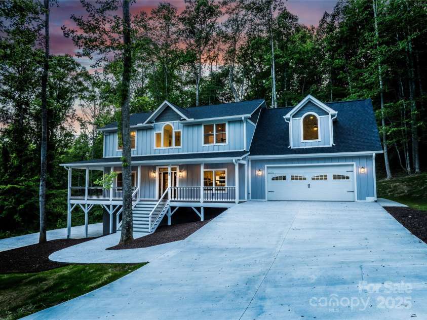68 Bamboo Trail, Candler, NC 28715.  MLS# CAR4257307, YatesRealty ID 24635. Lovely covered front porch and zero entry from the left of the main garage