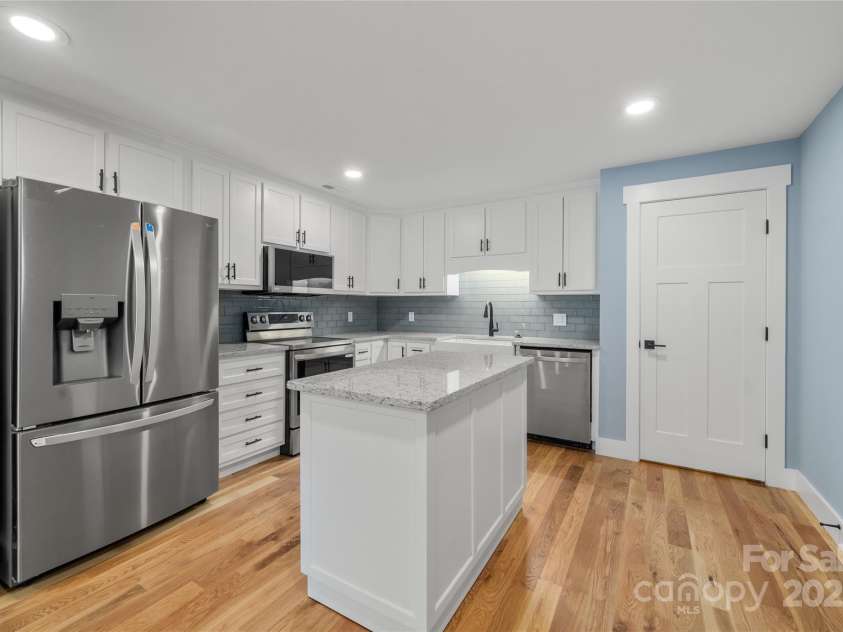 68 Bamboo Trail, Candler, NC 28715.  MLS# CAR4257307, YatesRealty ID 24635. Lower level full kitchen with portable island on wheels to reposition or relocate as you wish! Huge pantry on right behind door