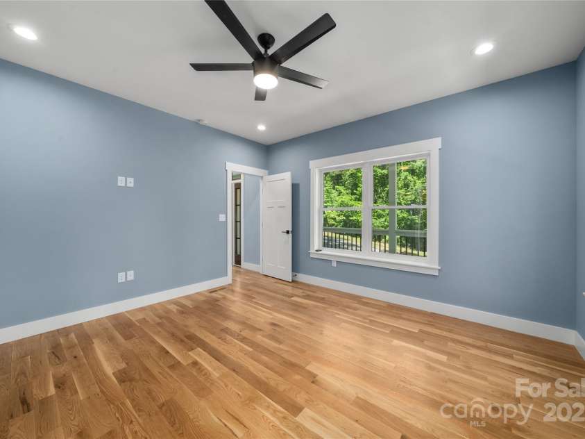 68 Bamboo Trail, Candler, NC 28715.  MLS# CAR4257307, YatesRealty ID 24635. Primary bedroom tucked away in corner of main level
