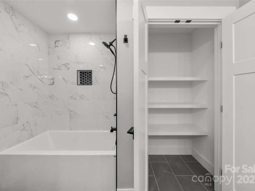 68 Bamboo Trail, Candler, NC 28715.  MLS# CAR4257307, YatesRealty ID 24635. Spacious bath with large linen closet