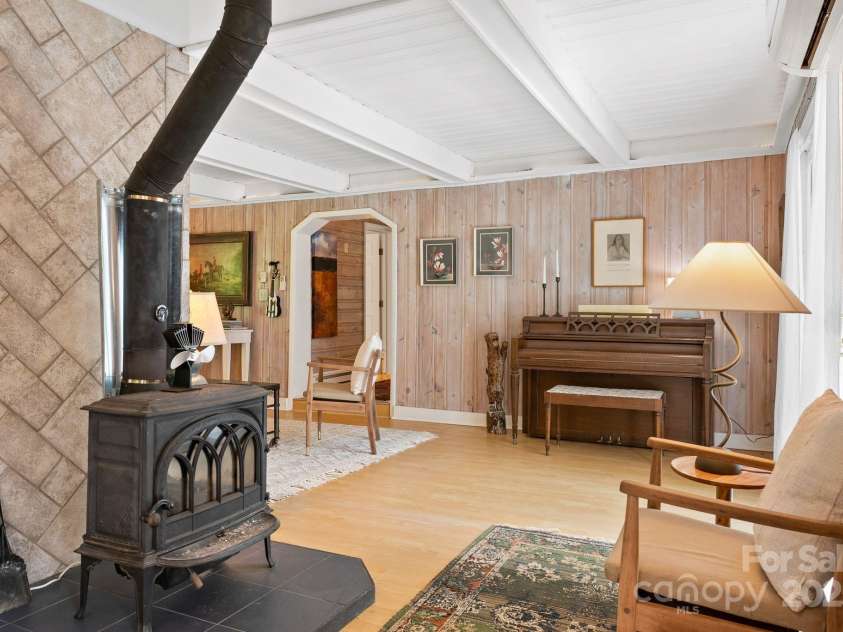 20 Pickens Lane, Weaverville, NC 28787.  MLS# CAR4267121, YatesRealty ID 24647. Living room with wood burning stove