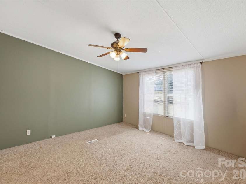 333 Howard Norton Drive, Hiddenite, NC 28636.  MLS# CAR4382521, YatesRealty ID 24658. Primary bedroom in this split level home
