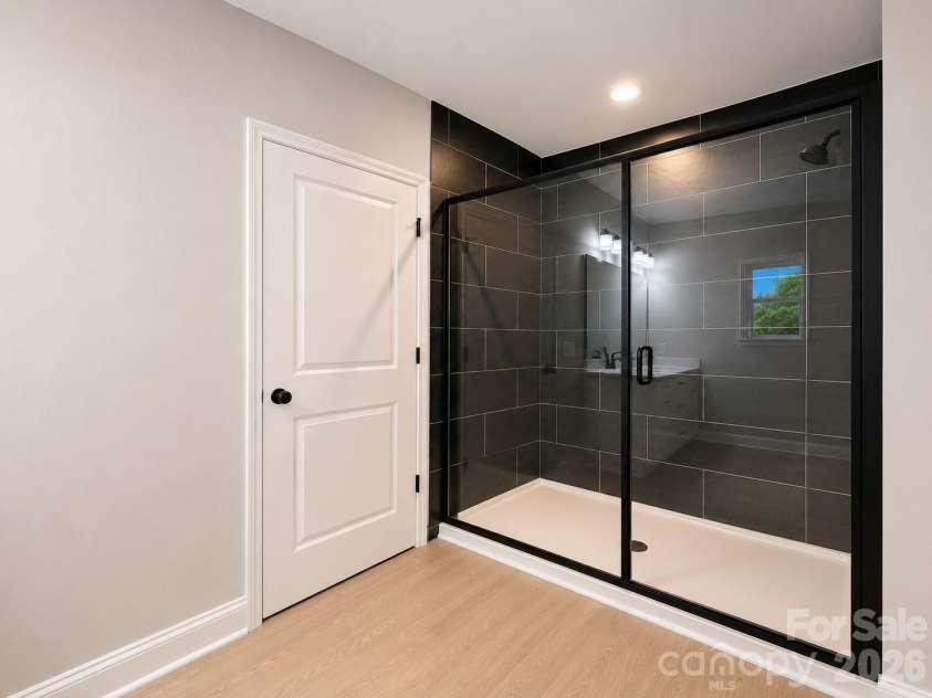 1002 Kingswood Drive, Monroe, NC 28112.  MLS# CAR4385415, YatesRealty ID 24679. Luxury walk in shower in Primary Bathroom
