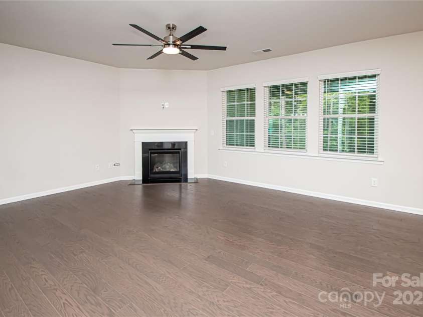 17718 Terryglass Lane, Charlotte, NC 28278.  MLS# CAR4274833, YatesRealty ID 24679. Family room has a gas fire place, ceiling fan and 3 large windows that overlooks the screened in porch and large backyard.
