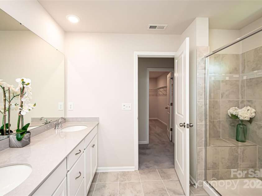 17718 Terryglass Lane, Charlotte, NC 28278.  MLS# CAR4274833, YatesRealty ID 24679. Master bathroom has large shower, sink with double vanity and tile floor