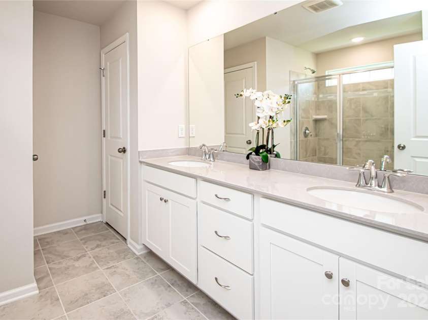 17718 Terryglass Lane, Charlotte, NC 28278.  MLS# CAR4274833, YatesRealty ID 24679. Master bathroom has large shower, sink with double vanity and tile floor