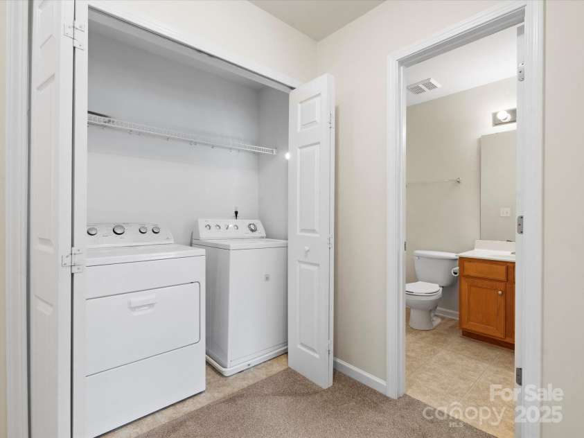 2137 Midnight Blue Lane, Fort Mill, SC 29708.  MLS# CAR4251116, YatesRealty ID 24727. Convenient laundry in the upstairs hallway with folding doors.  Washer dryer to convey