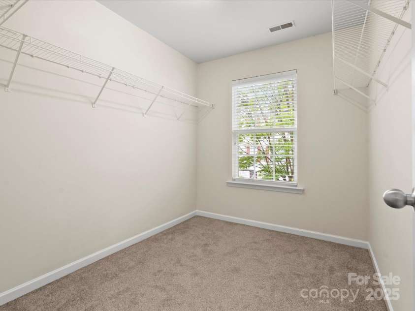 2137 Midnight Blue Lane, Fort Mill, SC 29708.  MLS# CAR4251116, YatesRealty ID 24727. Large walk in closet with a window in the primary