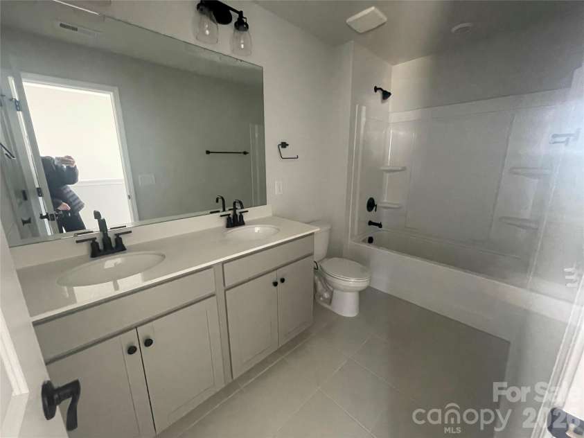 4049 Grommet Court, Matthews, NC 28105.  MLS# CAR4325054, YatesRealty ID 24731. Upstairs secondary bathroom with DUAL sinks and linen closet 