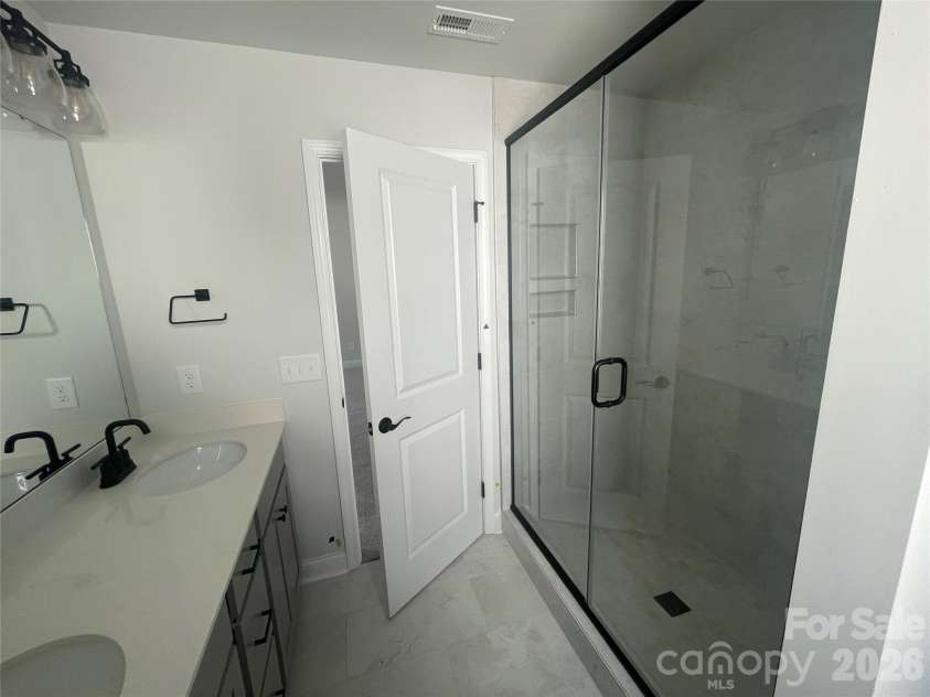 4049 Grommet Court, Matthews, NC 28105.  MLS# CAR4325054, YatesRealty ID 24731. Walk in shower with soap niche and tile to the ceiling 