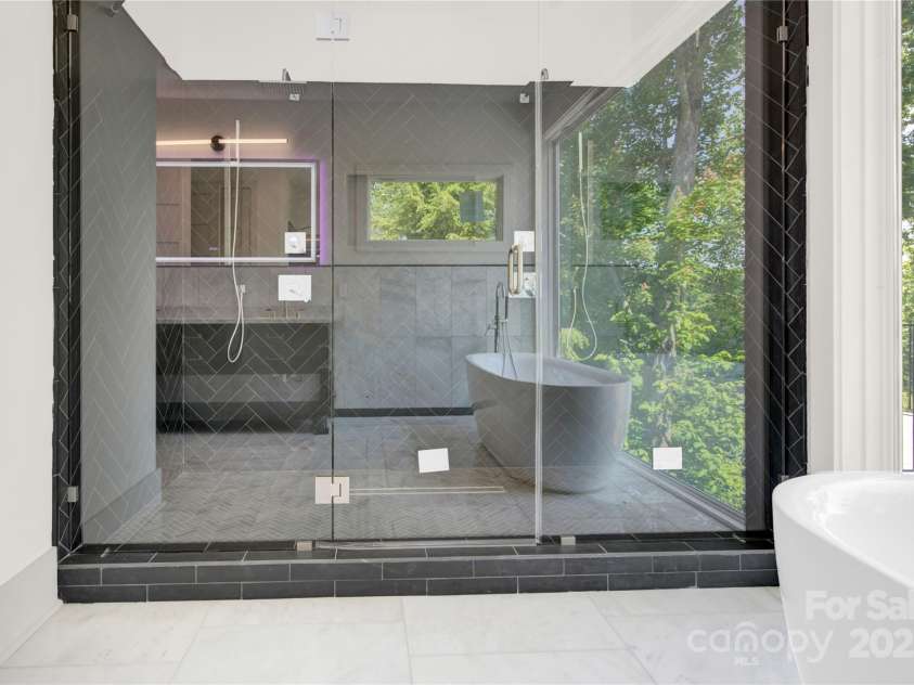 124 Clipper Lane, Mooresville, NC 28117.  MLS# CAR4253640, YatesRealty ID 24732. Expansive walk in shower with dual rain shower heads and seamless glass enclosure