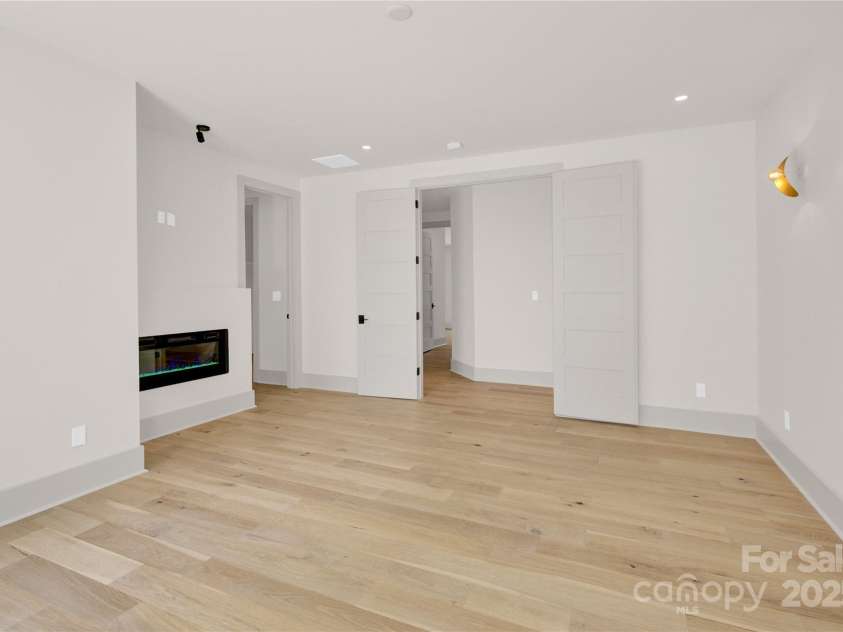 124 Clipper Lane, Mooresville, NC 28117.  MLS# CAR4253640, YatesRealty ID 24732. Upper level primary suite has electric fireplace
