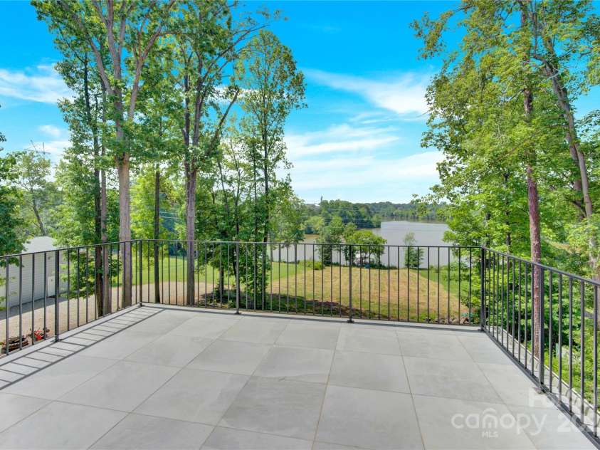 124 Clipper Lane, Mooresville, NC 28117.  MLS# CAR4253640, YatesRealty ID 24732. Walk out the upper level primary bedroom to your private lakefront balcony