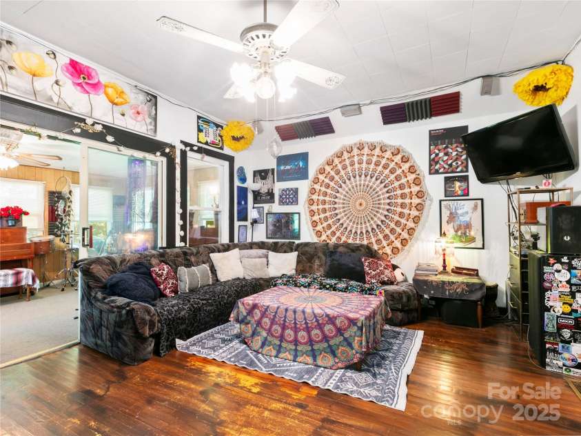 119 John Lee Montgomery Drive, Hendersonville, NC 28792.  MLS# CAR4277677, YatesRealty ID 24744. Living room bridges the sunroom and kitchen