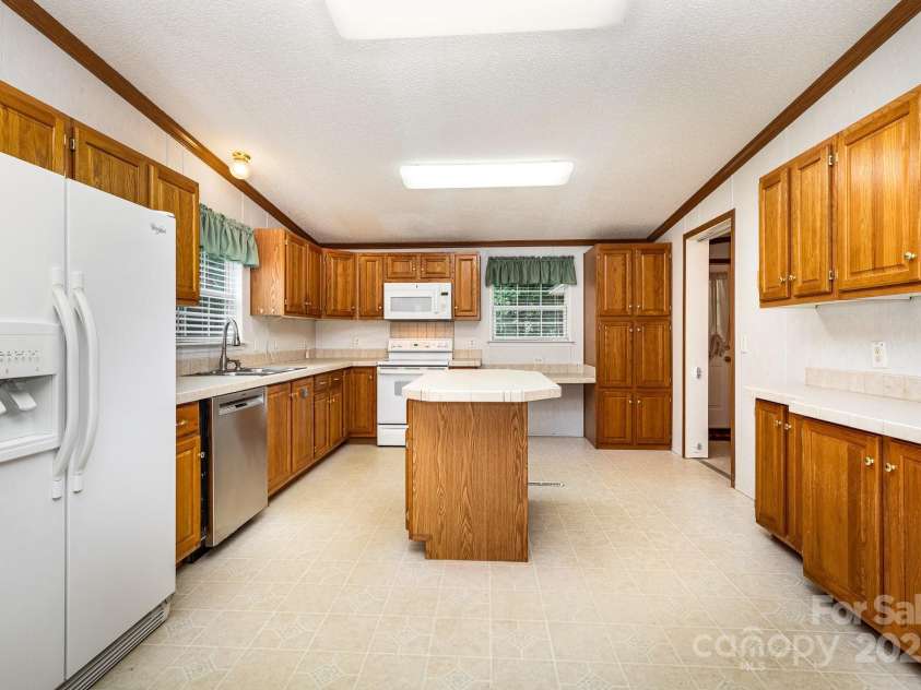 611 Robinson Street, Dallas, NC 28034.  MLS# CAR4261429, YatesRealty ID 24747. Lots of cabinets and counterspace!  Pantry cabinet provides lots of storage.