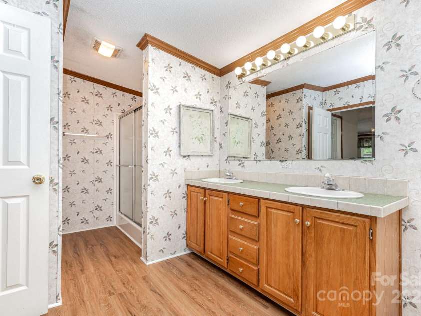 611 Robinson Street, Dallas, NC 28034.  MLS# CAR4261429, YatesRealty ID 24747. Primary Bathroom has 2 sink vanity and shower area.
