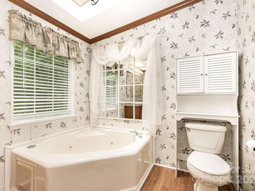 611 Robinson Street, Dallas, NC 28034.  MLS# CAR4261429, YatesRealty ID 24747. Primary Bathroom has large jetted tup and skylight.