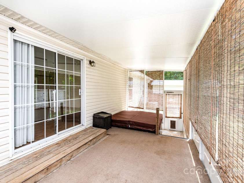 611 Robinson Street, Dallas, NC 28034.  MLS# CAR4261429, YatesRealty ID 24747. Screened porch off the living room is already set up with the hot tub!