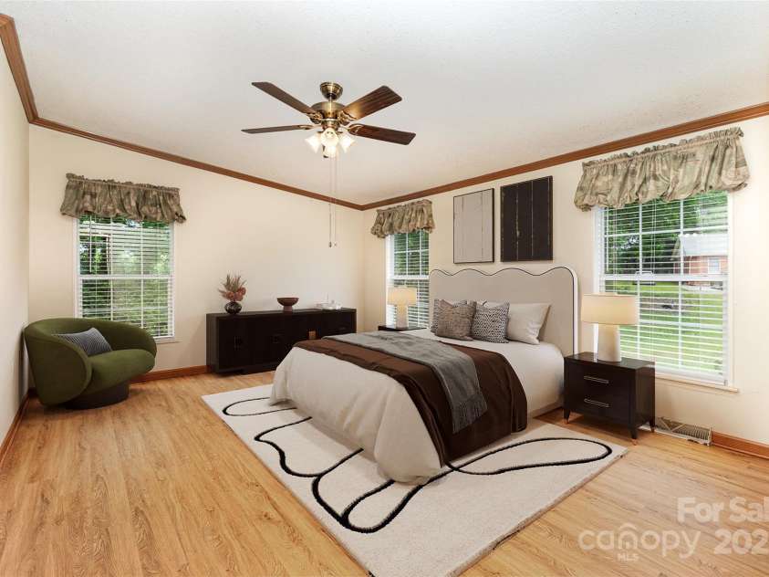 611 Robinson Street, Dallas, NC 28034.  MLS# CAR4261429, YatesRealty ID 24747. Virtually staged.  Restful primary suite includes the must have ceiling fan and 2 walk in closets.