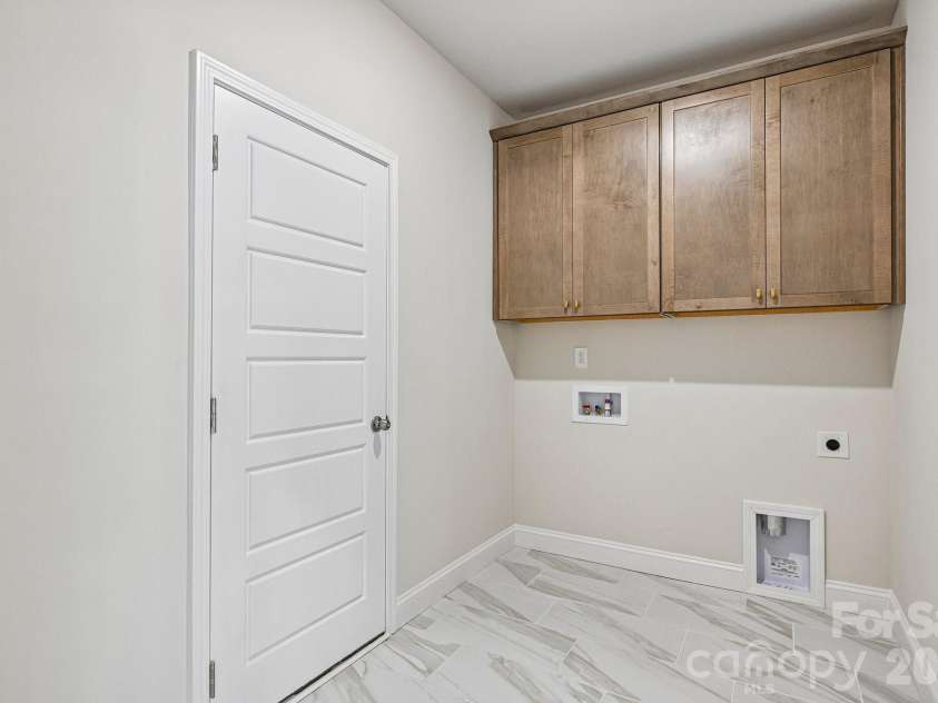 605 Banter Lane, Cramerton, NC 28032.  MLS# CAR4374152, YatesRealty ID 24768. Main/upper level walk-in laundry room with upper cabinets