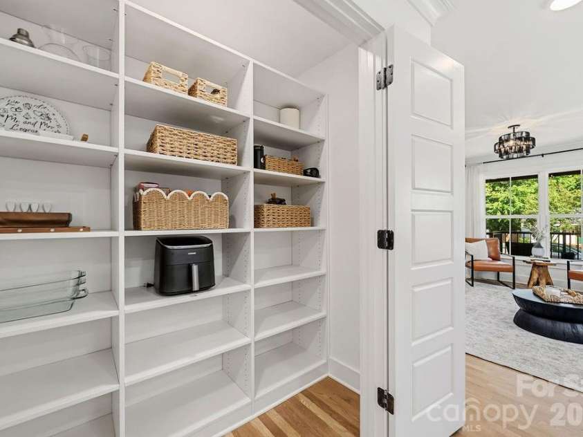 1939 Academy Street, Charlotte, NC 28205.  MLS# CAR4376177, YatesRealty ID 24770. Large Pantry with wooden shelves