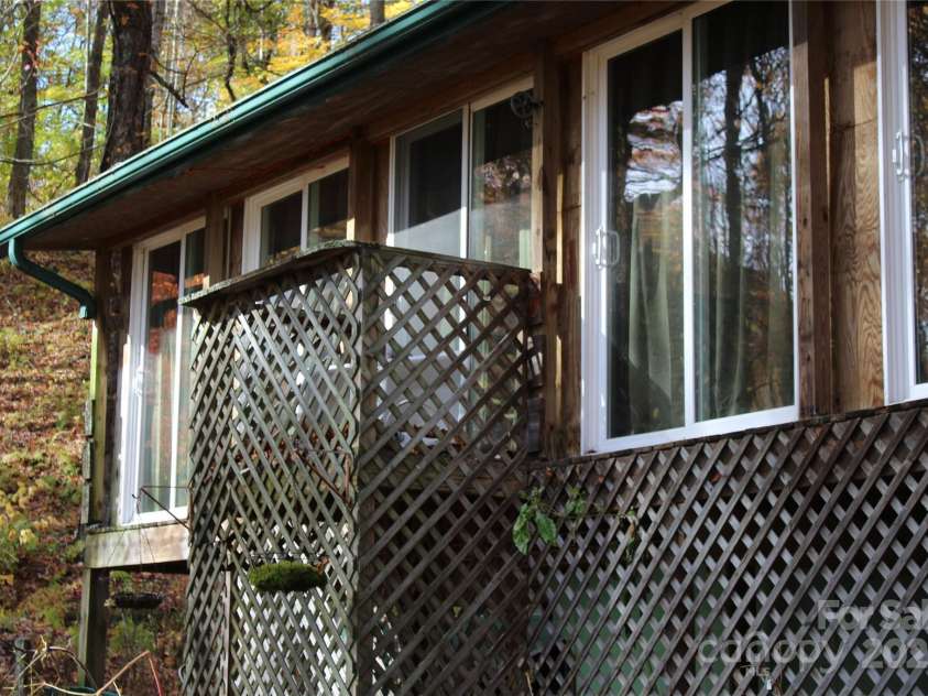 1571 Roaring Fork Road, Burnsville, NC 28714.  MLS# CAR4309867, YatesRealty ID 2480. Enclosed porch side of house