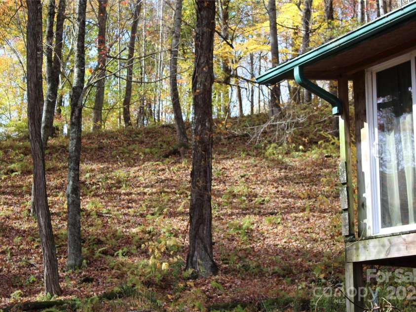 1571 Roaring Fork Road, Burnsville, NC 28714.  MLS# CAR4309867, YatesRealty ID 2480. Side of house looking up to the top of the ridge