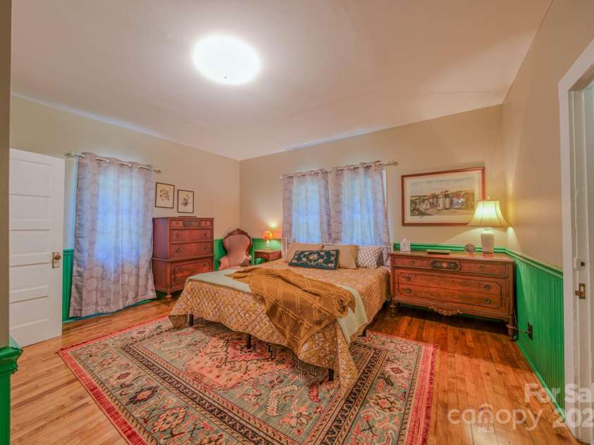 7 Bachelder Lane, Candler, NC 28715.  MLS# CAR4271857, YatesRealty ID 24801. Large bedroom features half bath and study/office