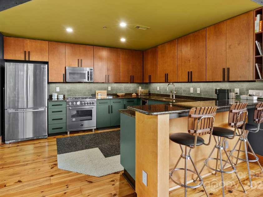 100 Coxe Avenue, Asheville, NC 28801.  MLS# CAR4271737, YatesRealty ID 24809. Kitchen area from dining area