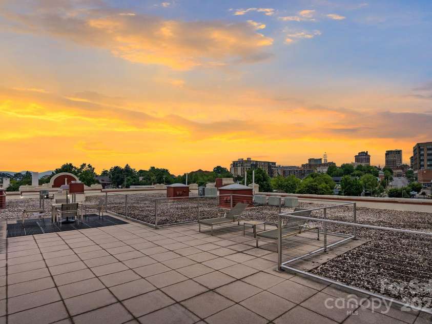100 Coxe Avenue, Asheville, NC 28801.  MLS# CAR4271737, YatesRealty ID 24809. Roof top terrace facing sunset