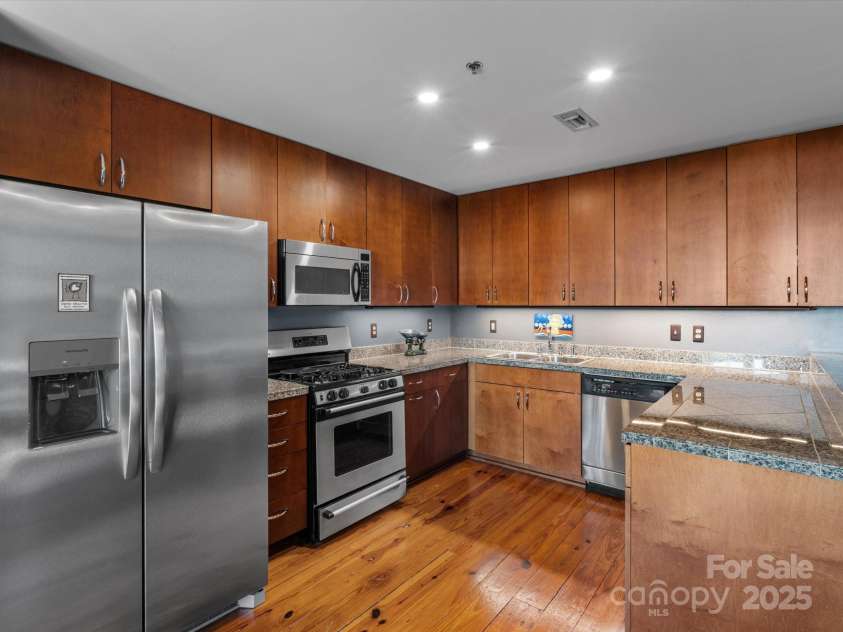 100 Coxe Avenue, Asheville, NC 28801.  MLS# CAR4307768, YatesRealty ID 24809. Bright and inviting kitchen designed for comfort, convenience, and modern living