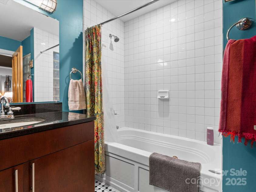 100 Coxe Avenue, Asheville, NC 28801.  MLS# CAR4307768, YatesRealty ID 24809. Deep tub and quality finishes in the bathroom