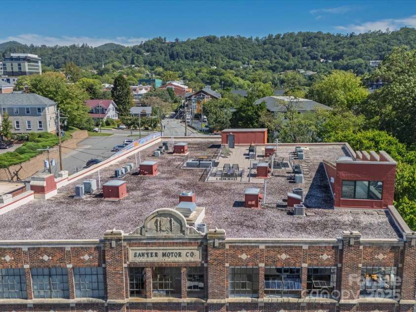 100 Coxe Avenue, Asheville, NC 28801.  MLS# CAR4307768, YatesRealty ID 24809. Elegant brick façade showcasing the building’s original architectural character