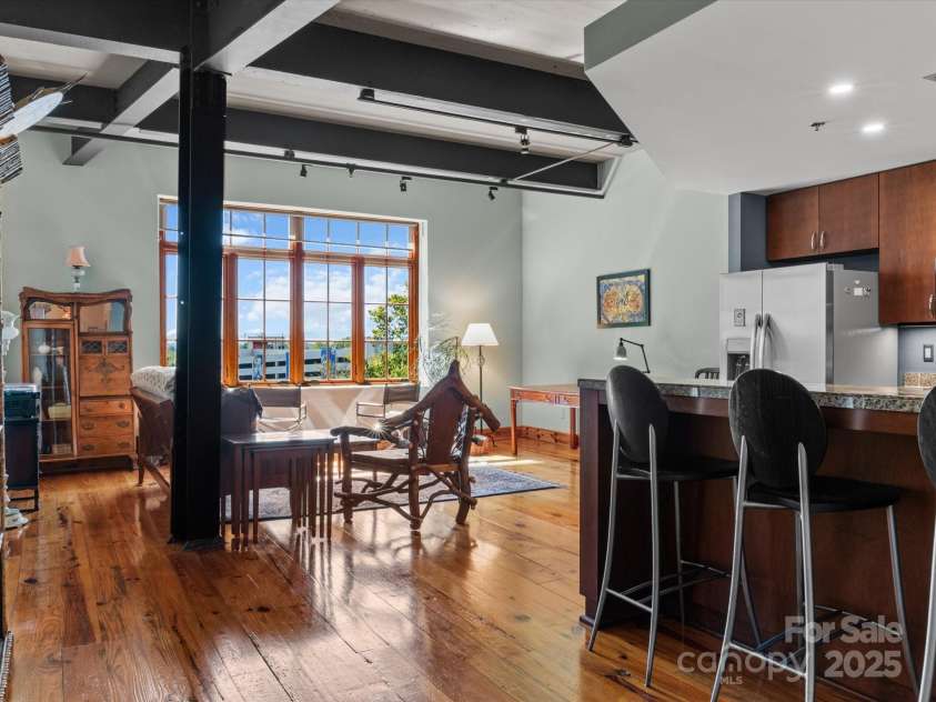100 Coxe Avenue, Asheville, NC 28801.  MLS# CAR4307768, YatesRealty ID 24809. Impressive ceiling height enhances the sense of openness and airiness