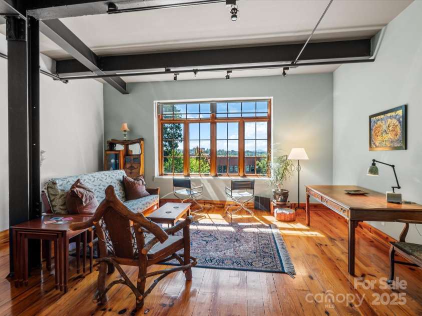 100 Coxe Avenue, Asheville, NC 28801.  MLS# CAR4307768, YatesRealty ID 24809. Inviting ambiance created by warm wood tones and natural light