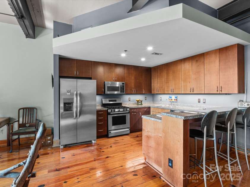 100 Coxe Avenue, Asheville, NC 28801.  MLS# CAR4307768, YatesRealty ID 24809. Open kitchen layout with connection to the living and dining spaces