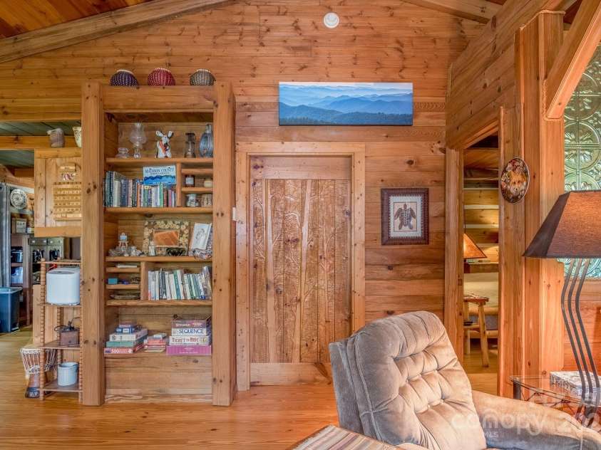 55 Bearwallow Road, Leicester, NC 28748.  MLS# CAR4278949, YatesRealty ID 24812. Built-In Bookshelves and Custom Carved Door