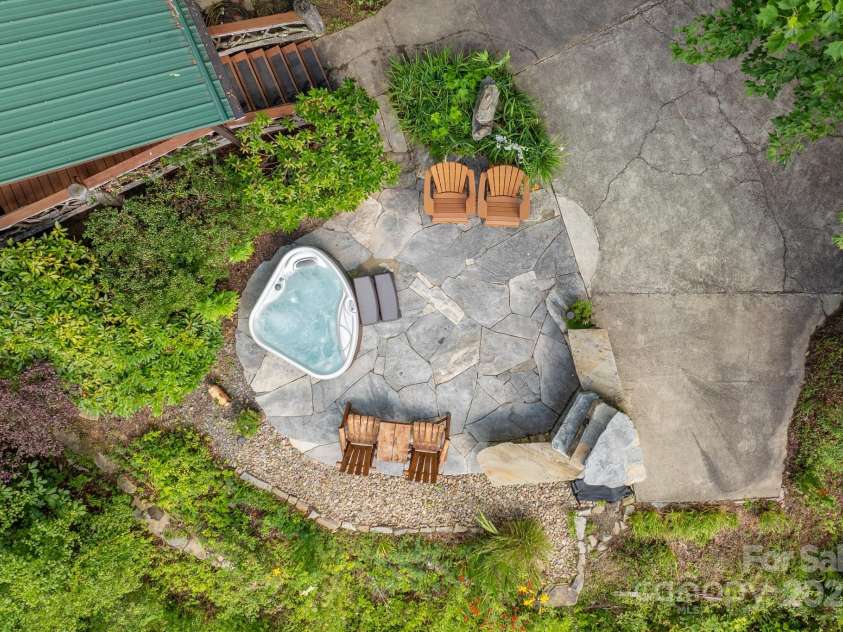 55 Bearwallow Road, Leicester, NC 28748.  MLS# CAR4278949, YatesRealty ID 24812. Patio with Outdoor Fireplace and Hot Tub for Enjoying the Views
