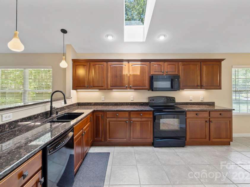 241 Fairway View Drive, Etowah, NC 28729.  MLS# CAR4304614, YatesRealty ID 2484. Kitchen with granite countertops and skylight for natural flow of light