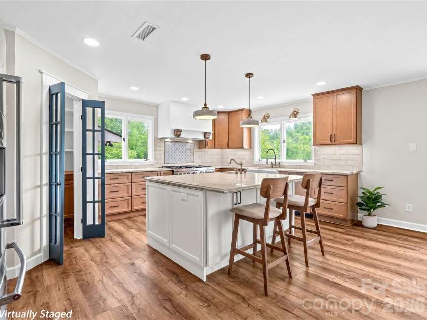 195 Red Bird Road, Spruce Pine, NC 28777.  MLS# CAR4380528, YatesRealty ID 24850. Chef's kitchen~ barstools and plant are virtual