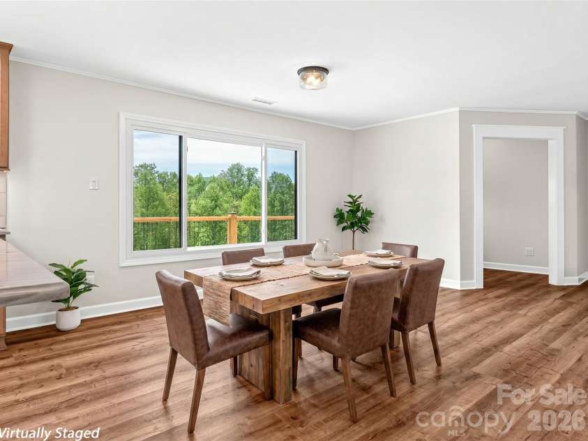 195 Red Bird Road, Spruce Pine, NC 28777.  MLS# CAR4380528, YatesRealty ID 24850. Dining area with long range views from window~ virtually staged