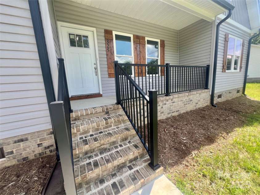 325 Jordan Avenue, Spencer, NC 28159.  MLS# CAR4269843, YatesRealty ID 24867. Concrete front porch with  metal railings for ease of maintenance